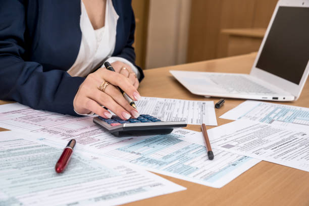Tax advisor calculating deductions on documents
